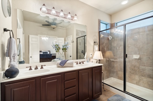 bathroom featuring tile patterned floors, ceiling fan, vanity, and an enclosed shower