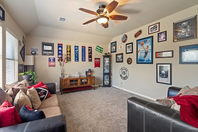 living room with carpet, ceiling fan, and vaulted ceiling