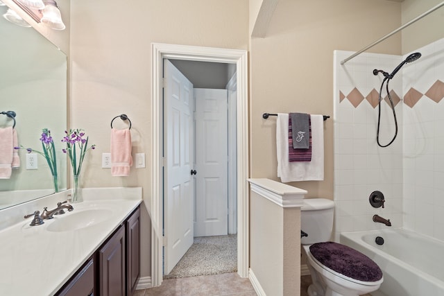 full bathroom featuring vanity, tile patterned flooring, tiled shower / bath, and toilet