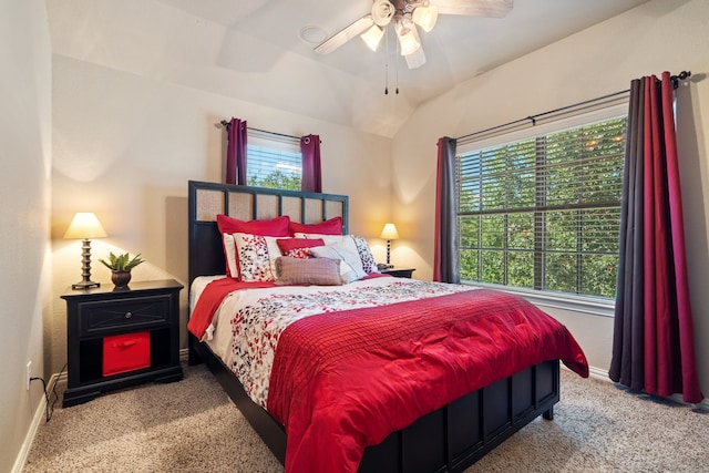 bedroom with ceiling fan, light colored carpet, and vaulted ceiling