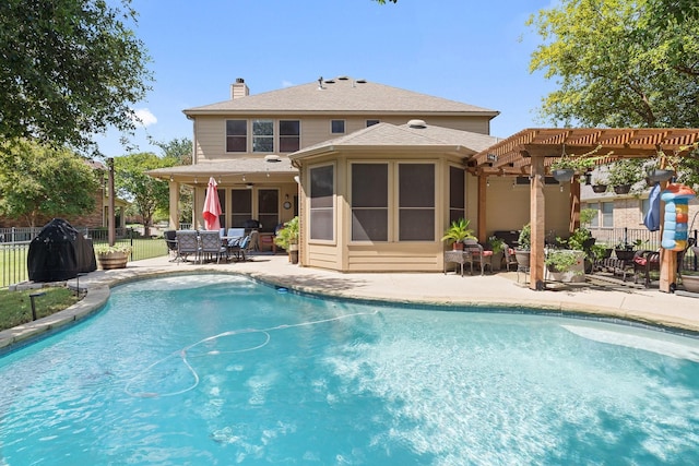 back of property featuring a sunroom, a fenced in pool, a pergola, and a patio