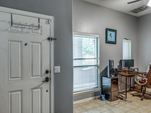 interior space with light tile patterned floors, ceiling fan, and a wealth of natural light