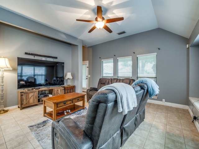 living room with ceiling fan, vaulted ceiling, and light tile patterned flooring