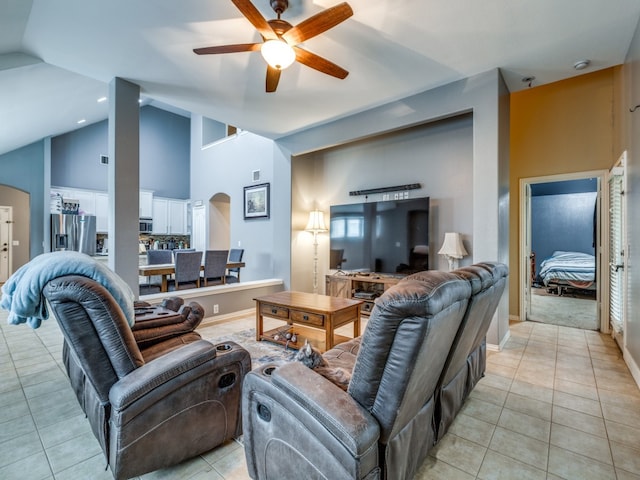 tiled living room featuring ceiling fan and high vaulted ceiling