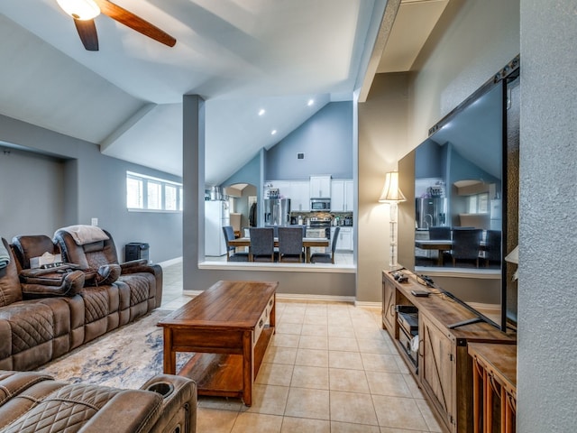 tiled living room featuring ceiling fan and high vaulted ceiling