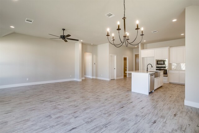 kitchen featuring a kitchen island with sink, appliances with stainless steel finishes, white cabinetry, and light hardwood / wood-style flooring