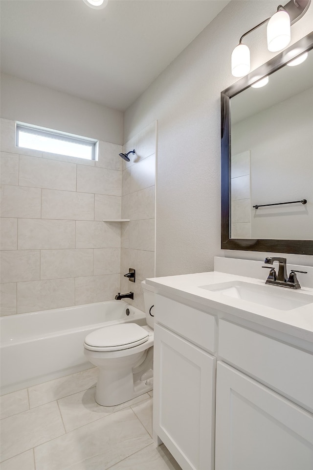 full bathroom featuring vanity, tiled shower / bath combo, and toilet