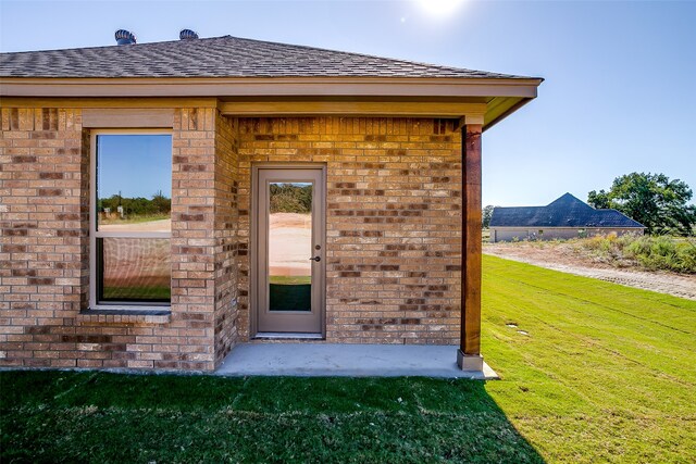 entrance to property with a lawn