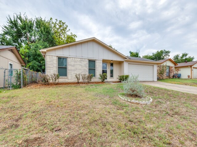 ranch-style house with a garage and a front yard