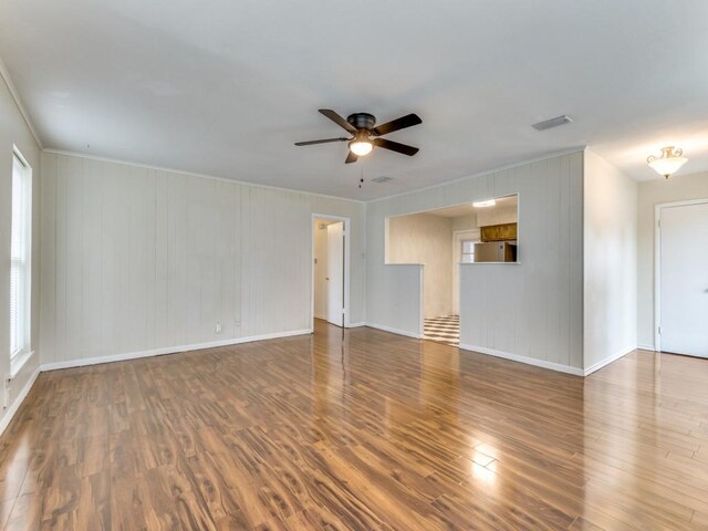 empty room with hardwood / wood-style floors and ceiling fan