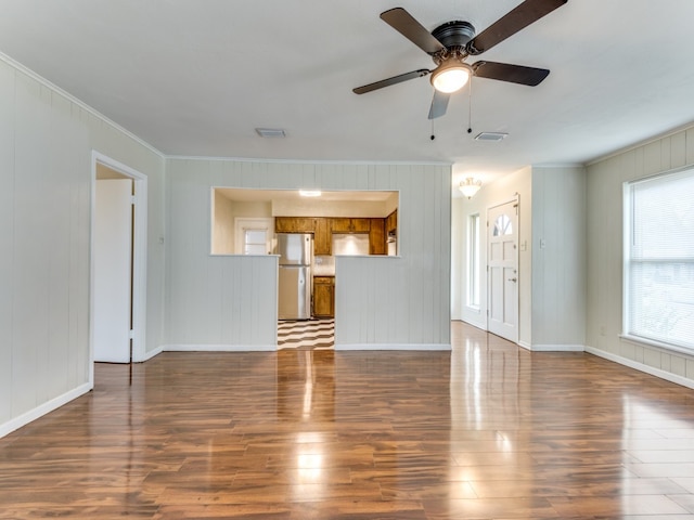 unfurnished living room with ceiling fan, dark hardwood / wood-style flooring, and ornamental molding