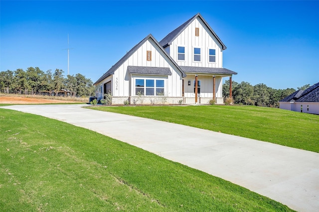 modern inspired farmhouse with covered porch and a front lawn