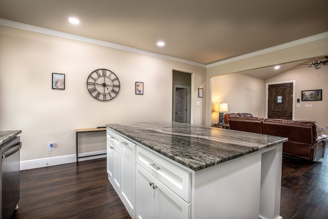 kitchen with white cabinetry, dark hardwood / wood-style flooring, a kitchen island, vaulted ceiling, and stainless steel dishwasher