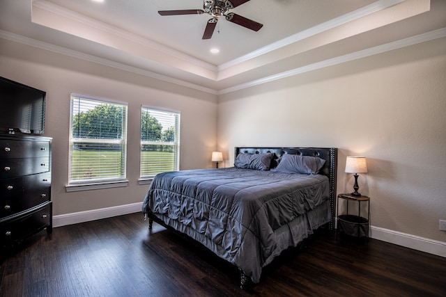 bedroom featuring crown molding, ceiling fan, a tray ceiling, and dark hardwood / wood-style flooring