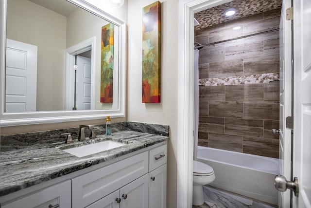 full bathroom featuring tiled shower / bath, toilet, and vanity