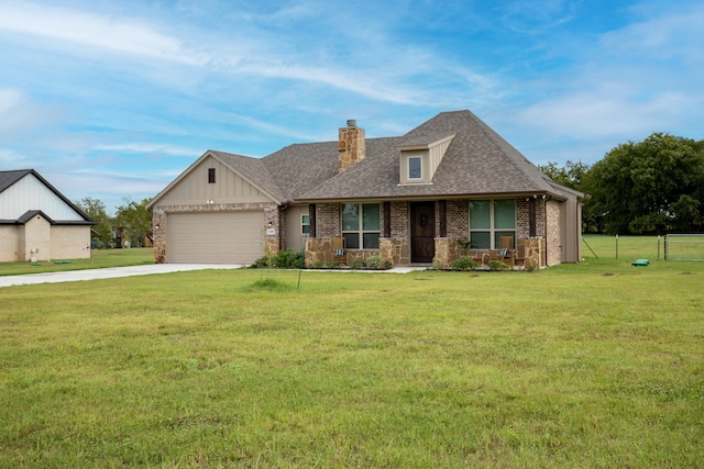 view of front of home featuring a garage and a front yard