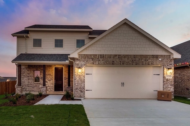 view of front facade with a garage and a yard