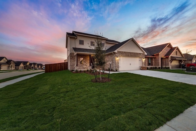 view of front of home with a yard and a garage