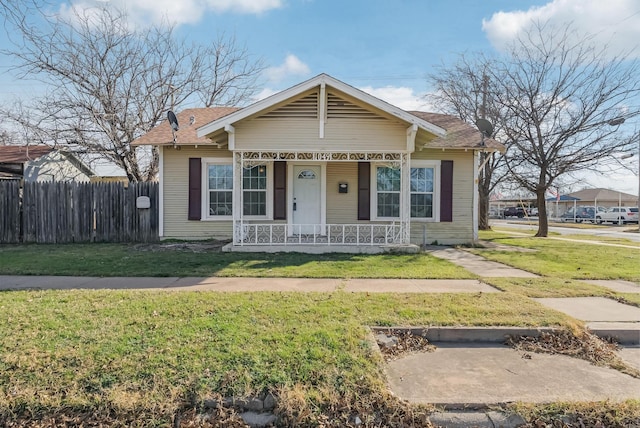 bungalow featuring a porch and a front lawn