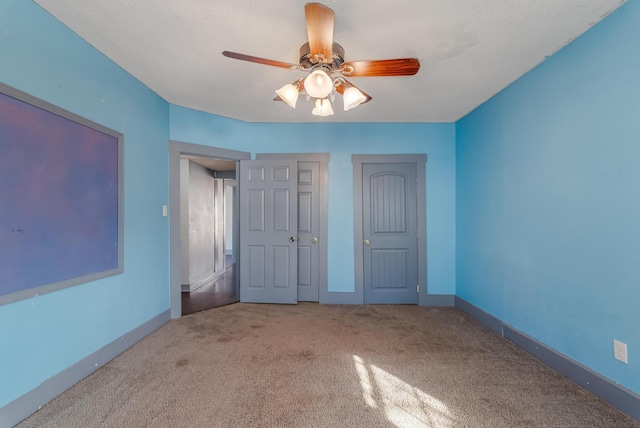 unfurnished bedroom with carpet and ceiling fan