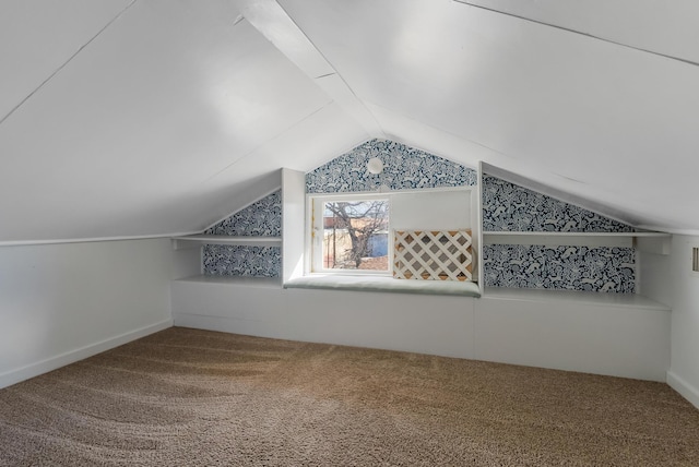 additional living space featuring lofted ceiling and carpet