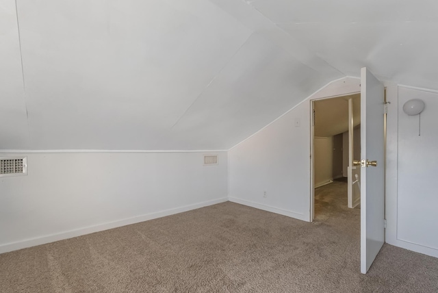 bonus room featuring vaulted ceiling and light colored carpet