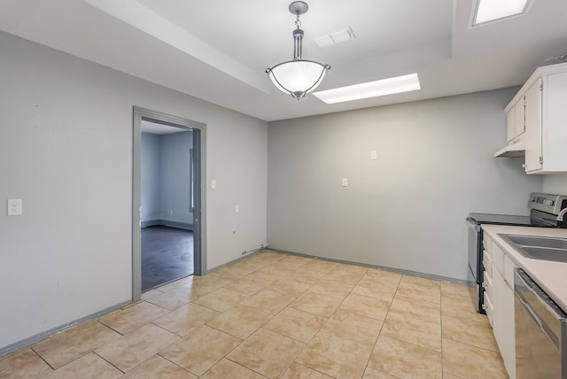 kitchen featuring white cabinetry, decorative light fixtures, light tile patterned floors, a tray ceiling, and stainless steel appliances