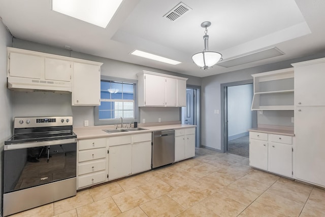 kitchen with appliances with stainless steel finishes, decorative light fixtures, white cabinetry, sink, and a raised ceiling