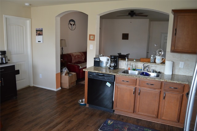 kitchen with decorative backsplash, dark hardwood / wood-style flooring, ceiling fan, sink, and black dishwasher