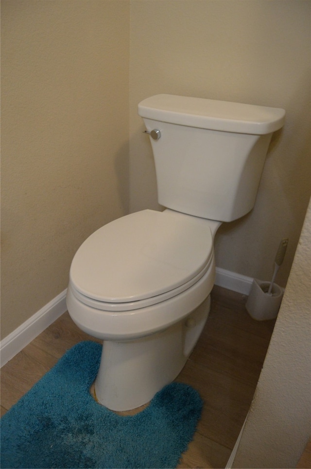 bathroom featuring hardwood / wood-style floors and toilet