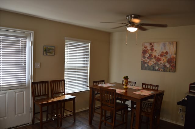 dining room with dark hardwood / wood-style floors and ceiling fan