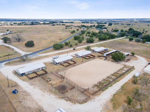 birds eye view of property with a rural view