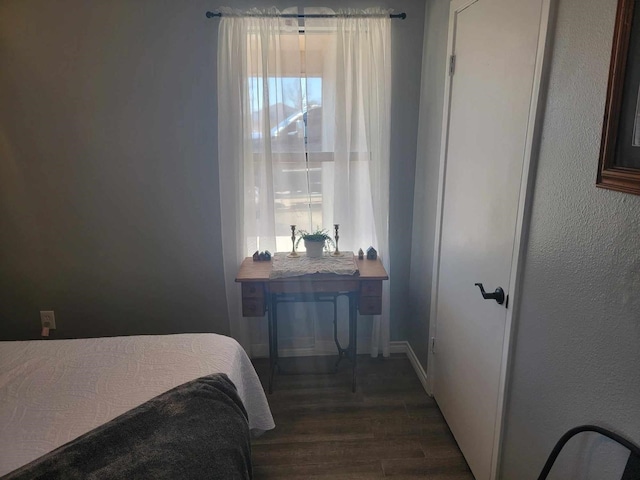 bedroom with dark wood-type flooring