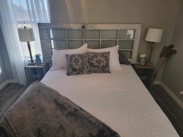 bedroom with dark wood-type flooring