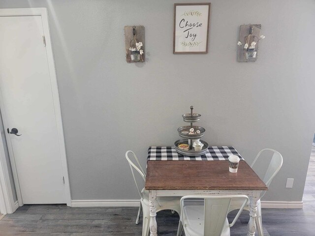 dining area featuring dark wood-type flooring