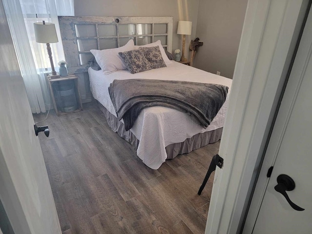 bedroom with hardwood / wood-style flooring