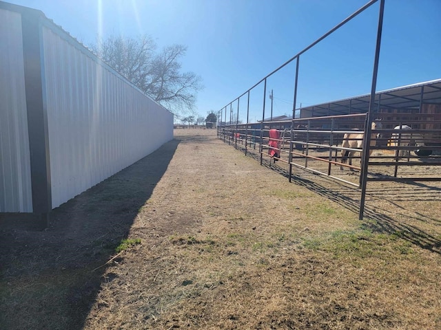 view of yard with an outdoor structure and a rural view