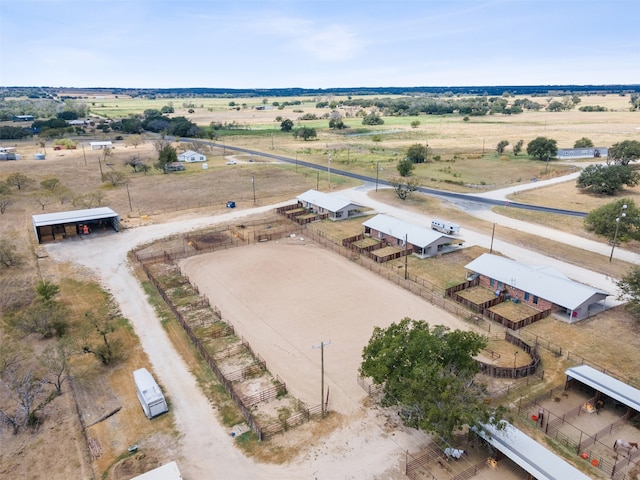 birds eye view of property with a rural view