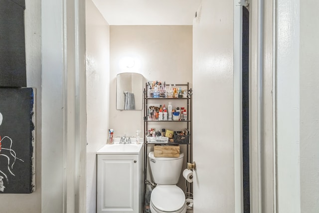 bathroom featuring toilet and vanity