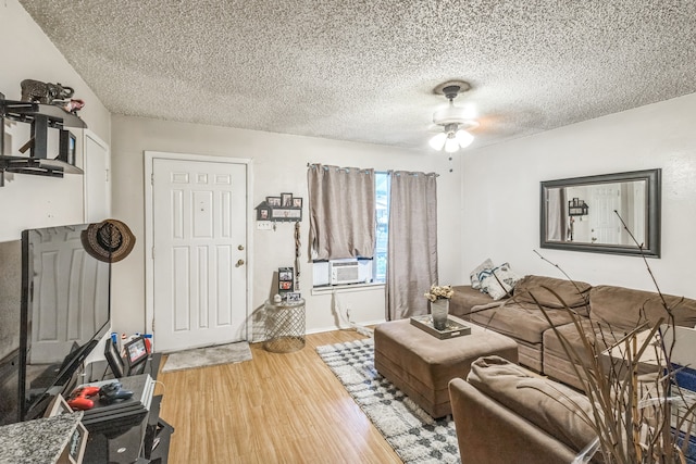 living room with a textured ceiling, cooling unit, ceiling fan, and light hardwood / wood-style floors