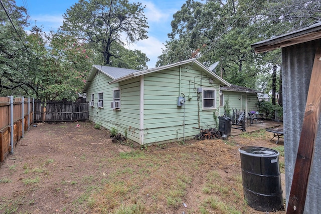 view of side of home with cooling unit and a patio