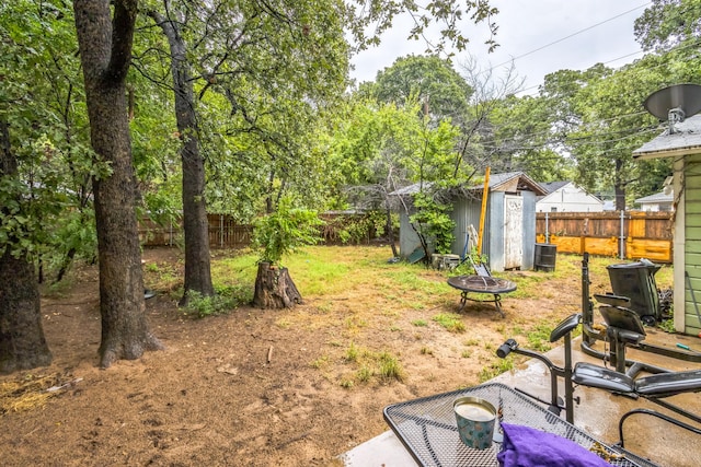 view of yard with central AC, a storage unit, and a patio area