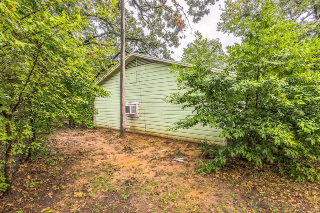 view of property exterior with an AC wall unit