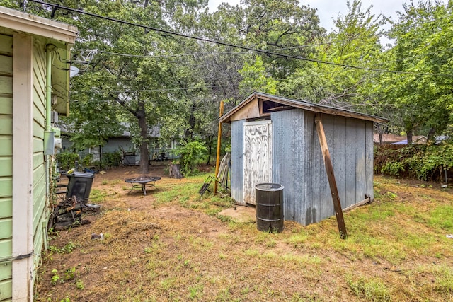 view of outbuilding featuring an outdoor fire pit