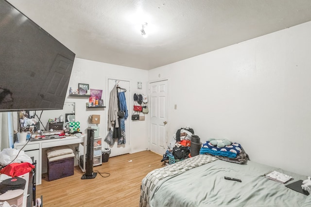 bedroom featuring a textured ceiling and light wood-type flooring