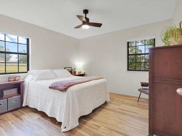 bedroom with ceiling fan and light hardwood / wood-style flooring