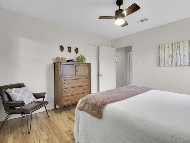 bedroom with ceiling fan and light hardwood / wood-style floors