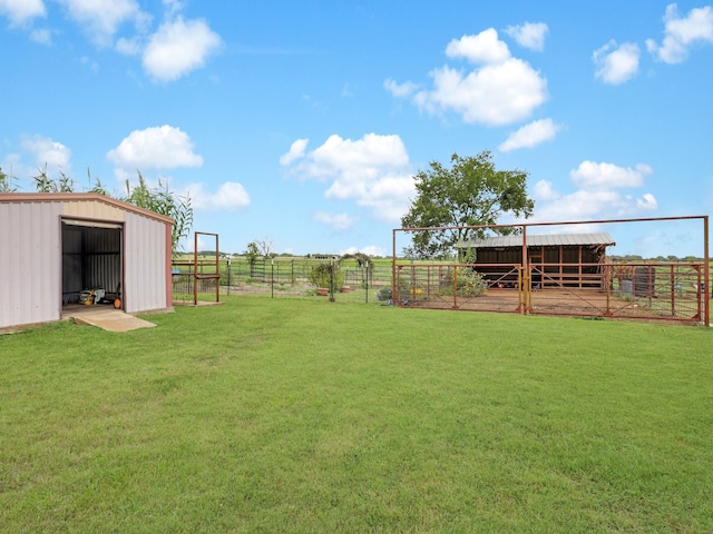 view of yard with a rural view and an outdoor structure