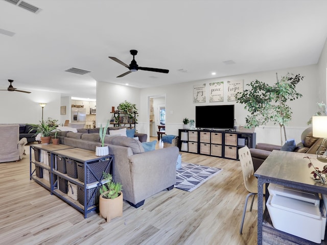 living room with ceiling fan and light wood-type flooring