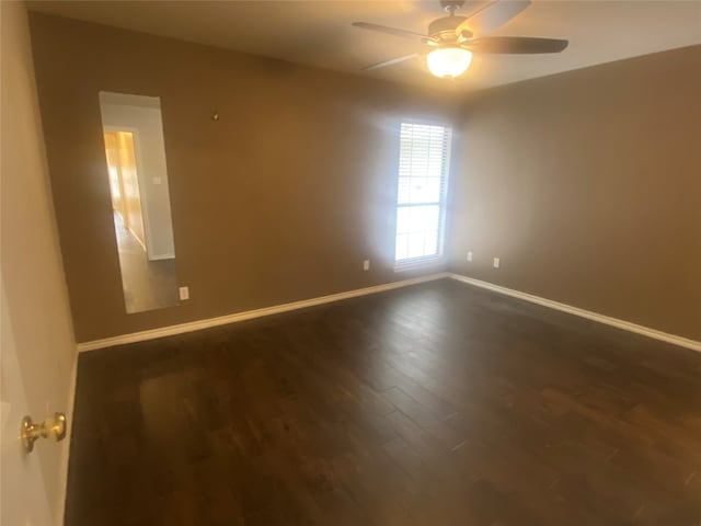 unfurnished room featuring dark wood-type flooring and ceiling fan